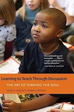 Learning to Teach Through Discussion